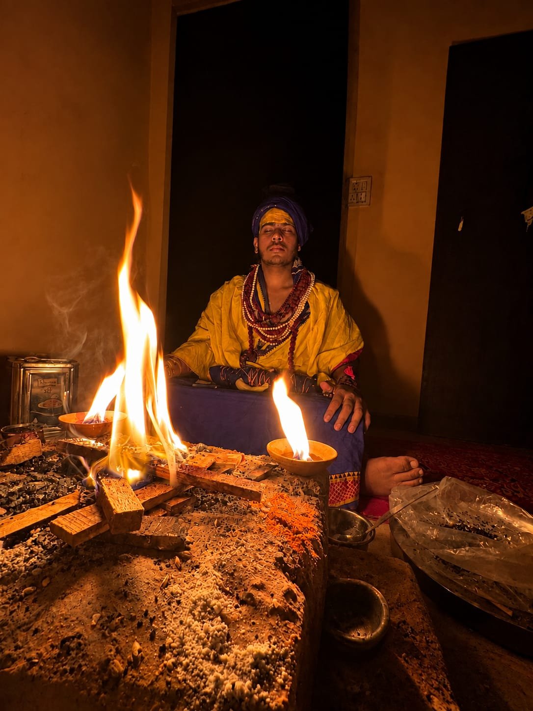 Yash Sharma meditating beside a sacred fire